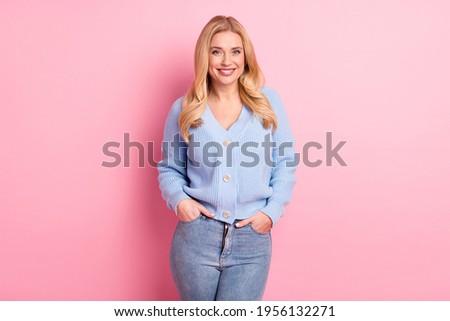 Photo portrait of woman wearing stylish blue cardigan jeans smiling isolated on pastel pink color background Royalty-Free Stock Photo #1956132271