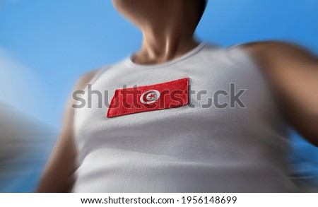 The national flag of Tunisia on the athlete's chest