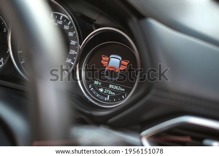 Close up Modern Black Car Dashboard with Door Open Graphic Sign and Steering Wheel as Foreground