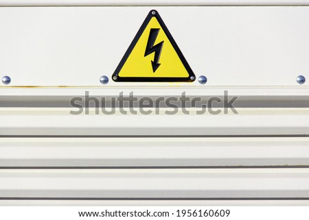 Yellow warning sign for high voltage on a gray background. Horizontal frame. Color of the year 2021. 