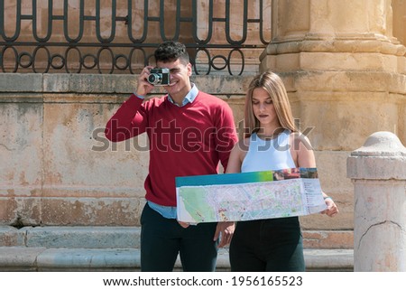 
a wedding couple looking at a tourist map