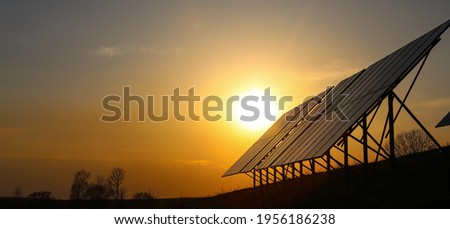 Solar panels Photovoltaic cells on orange sunset. Solar panels. Alternative energy concept Royalty-Free Stock Photo #1956186238