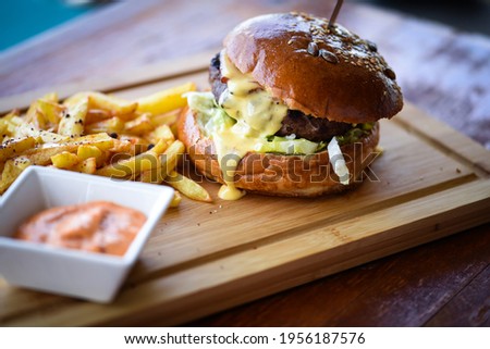 tasty delicious home made burgers with french fries Royalty-Free Stock Photo #1956187576