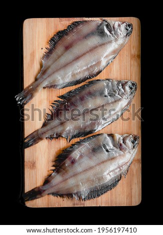 Raw flounder fish, seafood on a wooden cutting Board . Healthy eating concept.