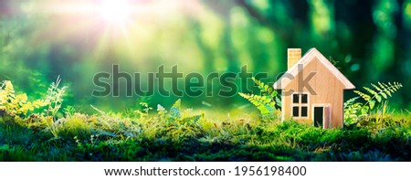 Eco House In Green Environment - Wooden Home Friendly On Grass Royalty-Free Stock Photo #1956198400