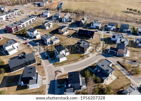 Aerial view of the roofs of country modern houses. Cottages, townhouses and line houses. Construction of modern residential complexes. Realtor and Real Estate concept. roofs of private houses
