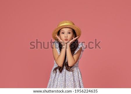 cute little child girl in summer dress and hat