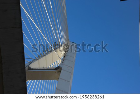 Bottom view of the cable-stayed bridge pylon in the place where the cables are fastened stays against the sky for the thematic banner