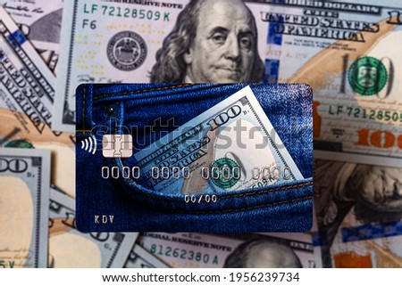 Debit card with dollars in pocket design on US 100 dollar banknotes background for design purpose