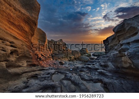 Russia. Dagestan. Dawn on the rocky shore of the Caspian Sea near the city embankment of Makhachkala. Royalty-Free Stock Photo #1956289723