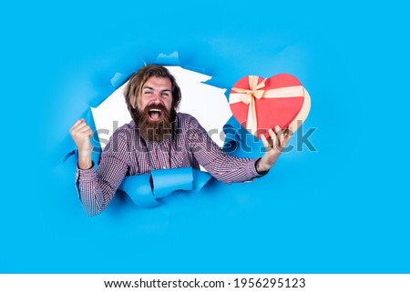 share his heart. best birthday present. be my valentine. man with gift box. guy with beard hold present. brutal caucasian hipster with moustache. male shopping concept. cyber monday and black friday