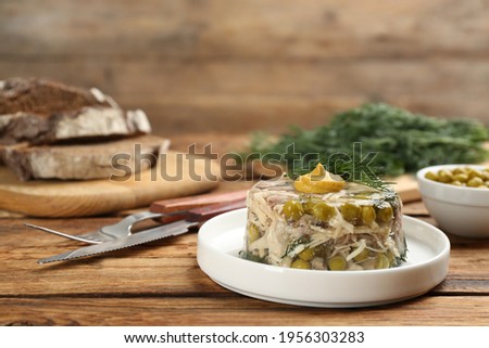 Delicious aspic with meat on wooden table, space for text