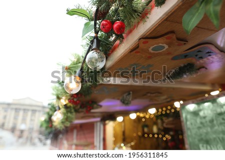 Christmas fair stall with string lights outdoors, closeup