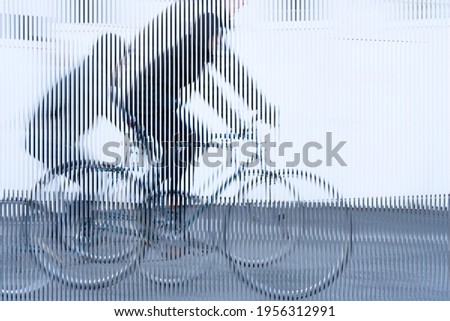 stripes image, movement of a cyclist with black jacket on white background