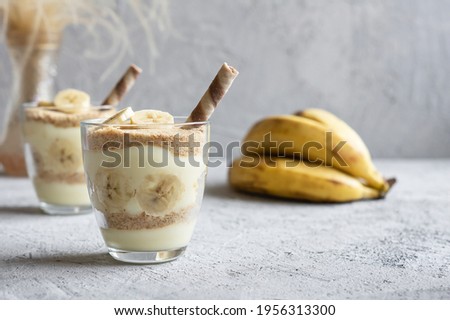 Magnolia dessert with fresh bananas in glass cup, homemade milky dessert concept
