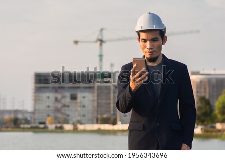 Asian man business using smartphone standing outdoor