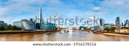 London, South Bank Of The Thames on a bright day in Spring or early Summer. Panoramic image taken from the Tower bridge, selective focus.