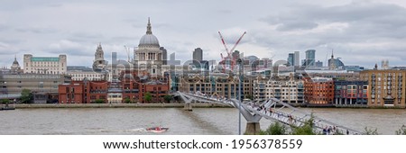 London, panoramic aerial view over Thames river with Millennium bridge, St. Paul and London skyline. Toned image, selective focus.