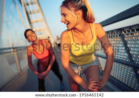 Beautiful women working out in a city. Running, jogging, exercise, people, sport concept