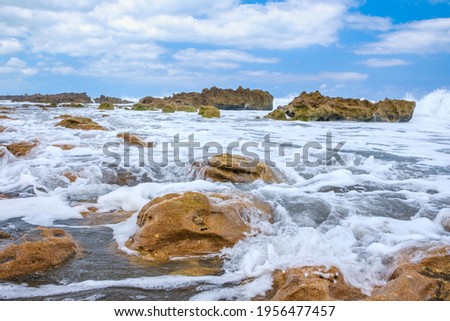 Waves crashing on the rocks on the beach at the Blowing Rock Preserve in Florida.