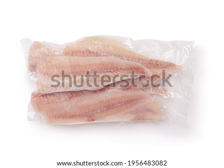 Top view of frozen pollock fillet in airtight clear plastic bag isolated on white Royalty-Free Stock Photo #1956483082
