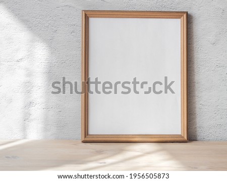 White portrait frame mockup on vintage wooden bench, table white gray concrete wall background. Scandinavian interior.