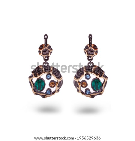 Long Gold Earring With colors precious stones, on white background . 