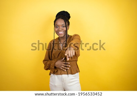 African american woman wearing casual clothes laughing at you, pointing finger to the camera with hand over body, shame expression