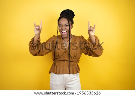 African american woman wearing casual clothes shouting with crazy expression doing rock symbol with hands up