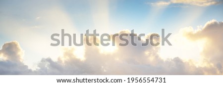 Clear blue sky with glowing pink and golden cumulus clouds after storm at sunset. Dramatic cloudscape. Concept art, meteorology, heaven, hope, peace, graphic resources, picturesque panoramic scenery