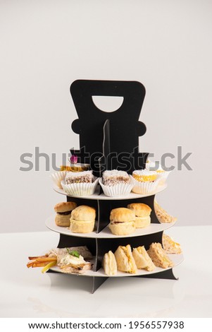 Mini mixed sandwiches with french fries and cheese in brown wooden plate on white background,.
