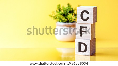 CFD abbreviation - Contract For Difference, on wooden cubes on a light background