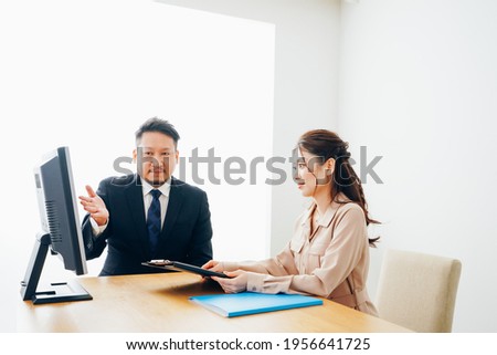 Two business persons working at an office