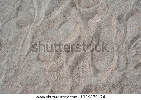 Footprints on the soft sandy beach. 