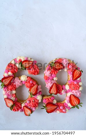 Birthday cake. Unusual modern design with strawberries. Spring time. Postcard for the holiday. Congratulations are bright and creative. Beautiful cake in the shape of number 69