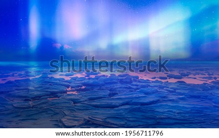 Cracks on the surface of the green ice next to white lone house (cabin) in winter - Frozen lake - Northern lights in the sky over Tromso, Norway Royalty-Free Stock Photo #1956711796