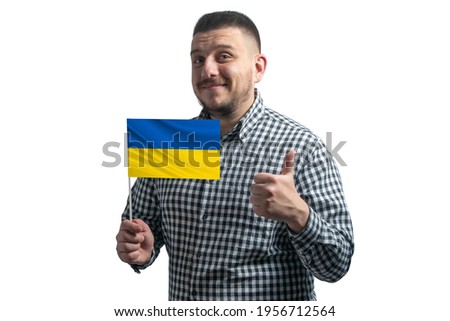 White guy holding a flag of Ukraine and shows the class by hand isolated on a white background. Like for Ukraine.