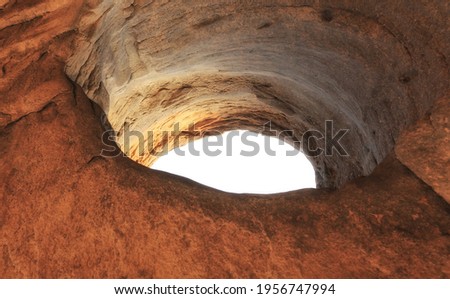 An old stone well from inside. Picture taken from below.View from inside a cave looking out.Air hole to the ground level floor from underground cave