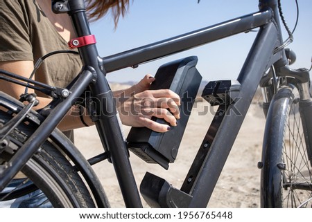 inserting e-bike battery on frame