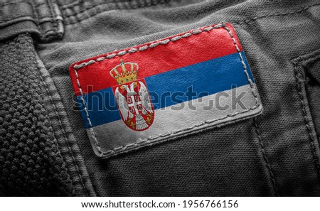 Tag on dark clothing in the form of the flag of the Serbia