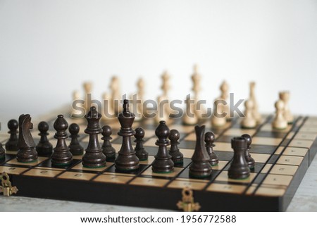 initial position is the initial position of the chess pieces on the chessboard. The main plan of the figure is brown in natural wood