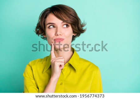 Photo portrait of dreamy cunning girl touching face looking empty space isolated on vivid teal color background