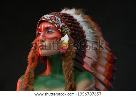 Beautiful female model with painted skin and tribal headwear