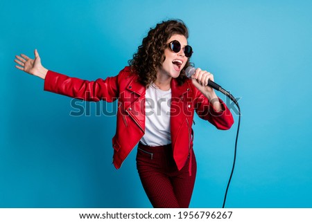 Photo of funny curly hairstyle young girl sing open mouth wear round sunglass good mood isolated on blue color background Royalty-Free Stock Photo #1956796267