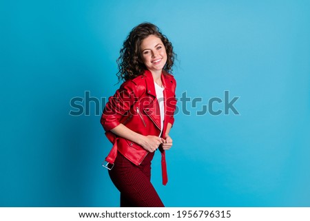 Profile photo of optimistic girl wear red jacket trousers isolated on blue color background