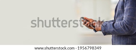 Businessman using smart phone in blurred office space background and copy space.Concept of business people use technology. Close up of a man using mobile smart phone. Banner