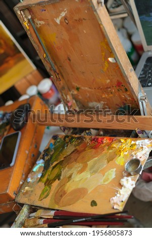 Palette, paint and brushes for the artist
