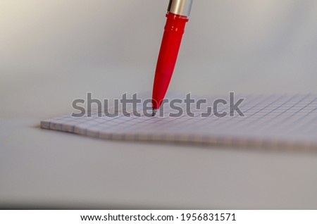 red pen making notes on paper