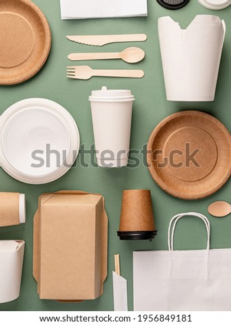 Knolling concept. Eco friendly zero waste disposable tableware top view flat lay on green background. Pattern Royalty-Free Stock Photo #1956849181