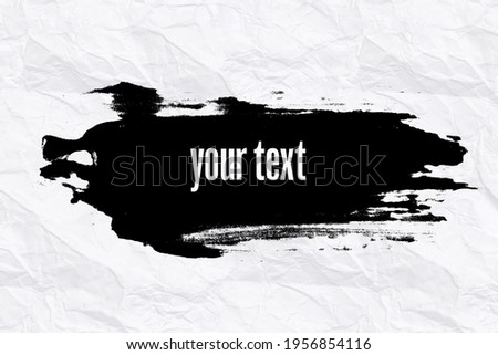 black banner on a white crumpled sheet of paper. advertisement. uneven stroke on the white backdrop. High quality photo